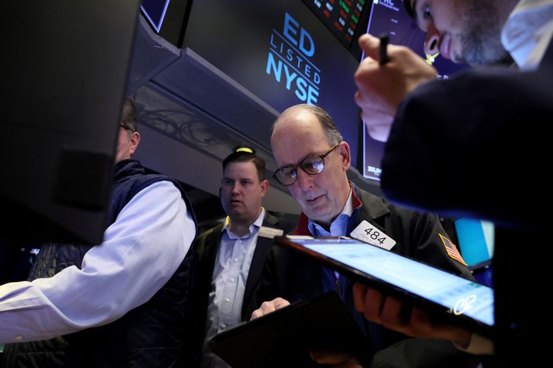 Wall Street ends down with tech; investors assess bank comments